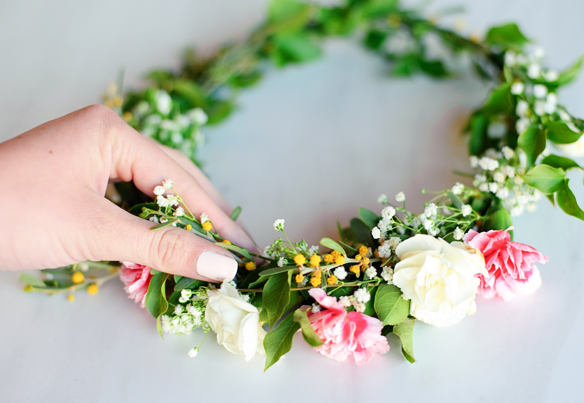 Hand on a flower crown.