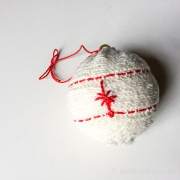 White sweater ornament with red embroidery