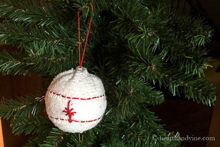 Sweater ornament with red stitching on tree