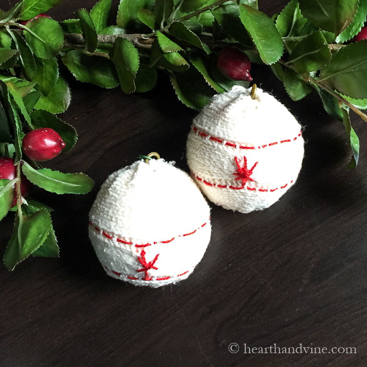 Two embroidered sweater ornaments