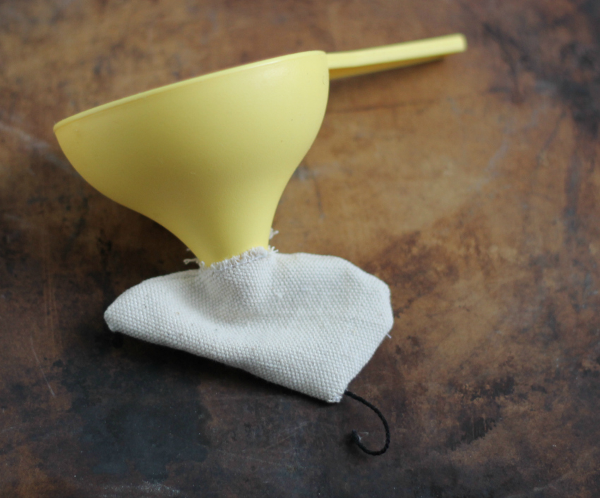 Using a funnel to fill the fabric mouse