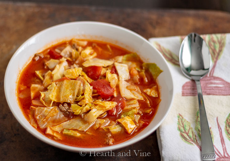 Stuffed cabbage soup in a bowl with a spoon.