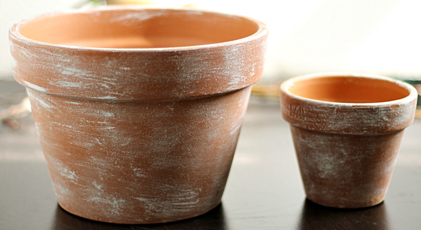 White washed terra cotta pots. One large and one small.