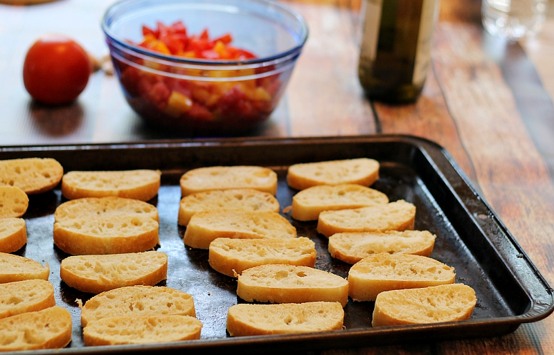 Toasted baguette slices on cookie sheet