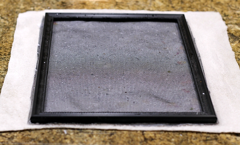 Handmade paper frame with pulp on cloth