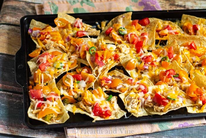 Low acid tomato chicken nachos on baking sheet