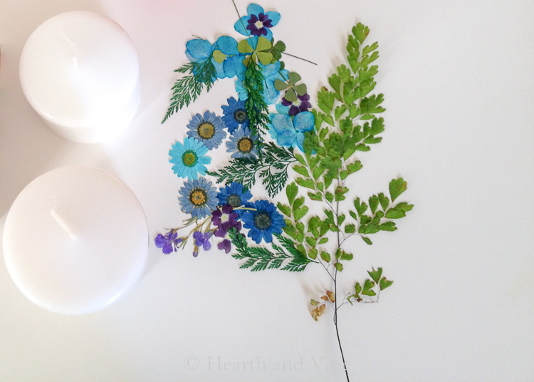 Two plain pillar candles and some pressed flowers