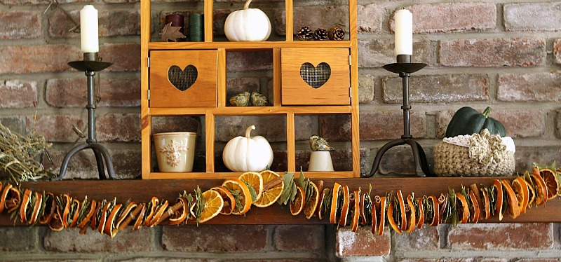 Orange bay leaf and cinnamon garland on mantel.