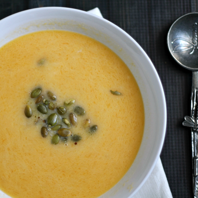 Bowl of butternut squash soup with roasted pepitas.