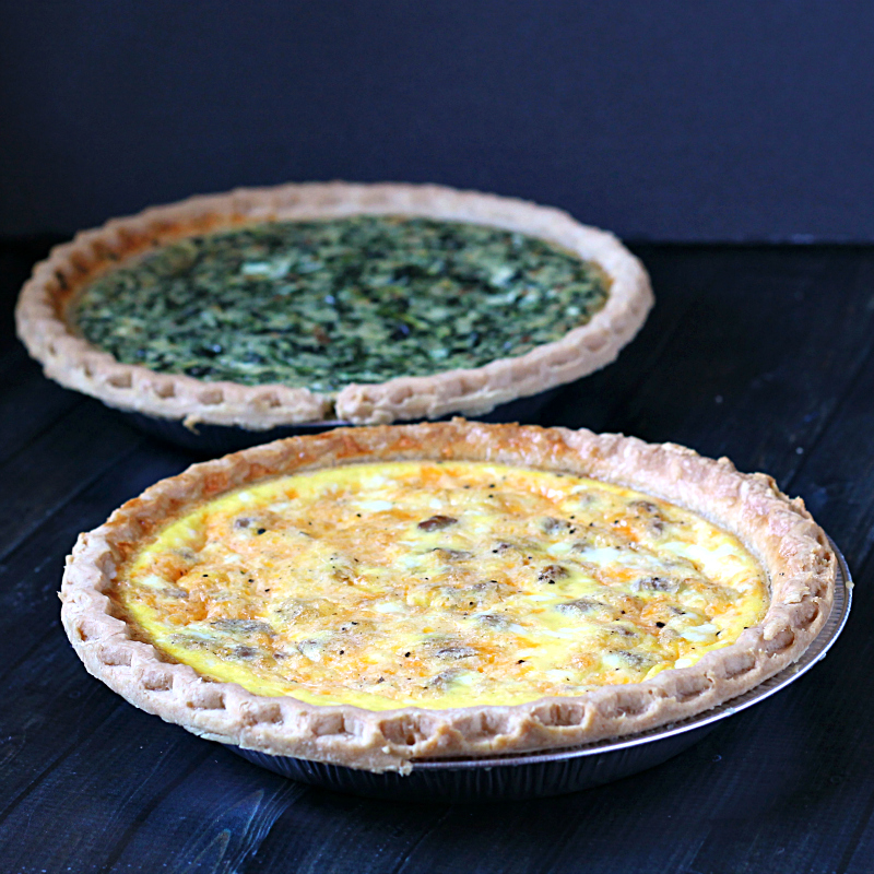 Two quiches. One spinach and one sausage and cheese