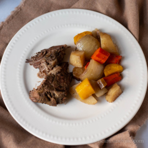 Plate with pot roast and root vegetables.