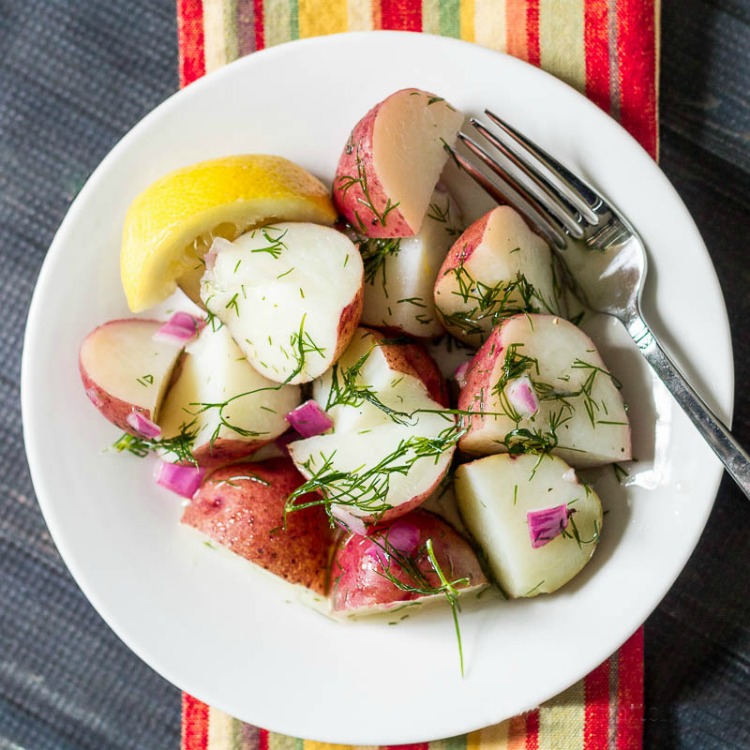 Plate of red potato salad with dill and grapeseed oil.