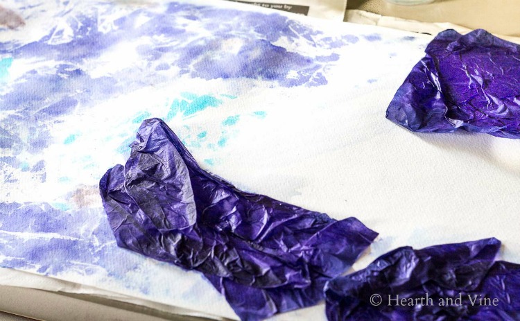 Painting the paper background with tissue paper