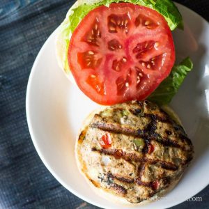 Southwest turkey burger on a bun with lettuce and tomato.