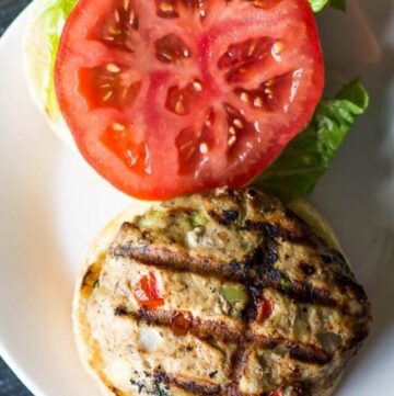 Southwest turkey burger on a bun with lettuce and tomato.