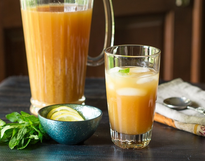 Glass of Fruit Tea next to a pitcher