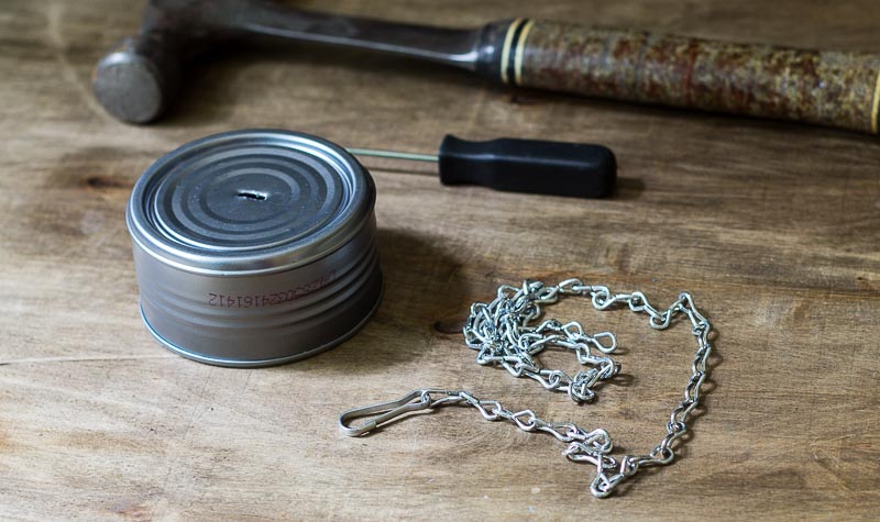 DIY wind chime top made from a clam aluminum can and a chain for hanging.