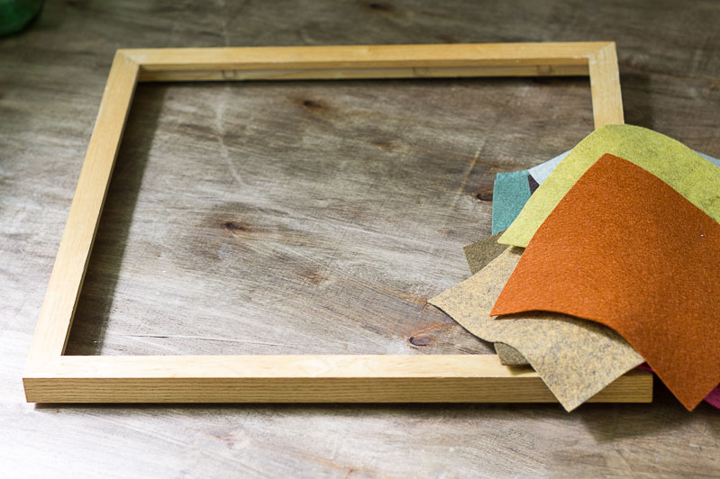 Supplies for felt flower wreath including, wood frame and fall colored felt.