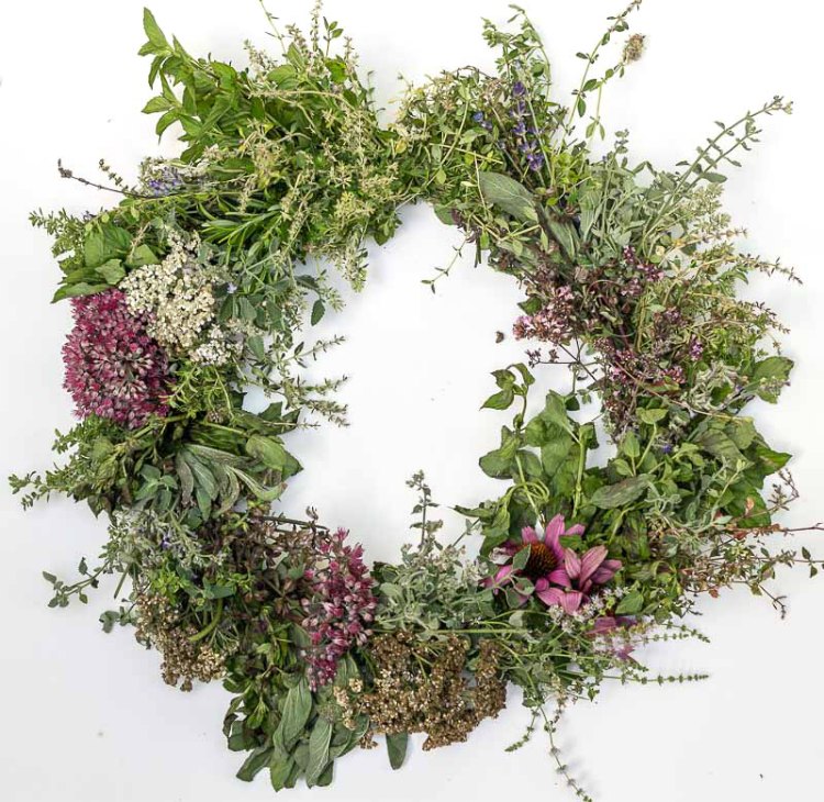 Fresh wreath made with herbs and flowers.