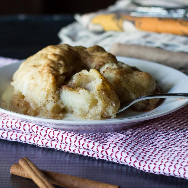 Baked apple dumpling broken open with a fork.