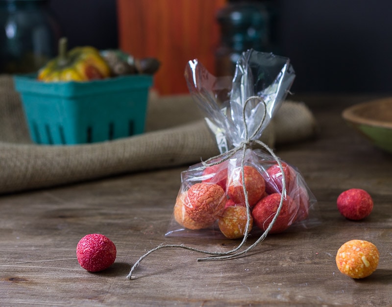 Homemade soap balls in a plastic bag tied with a piece of twine a few additional soap bowls scattered around the table.