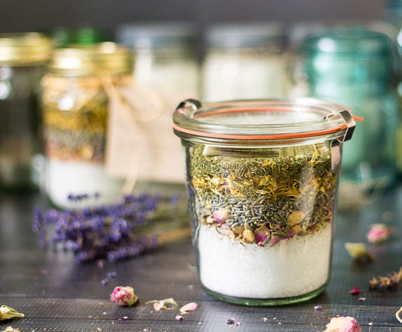 A fancy weck jar with a rubber seal storing the bath salts and herb layers. 