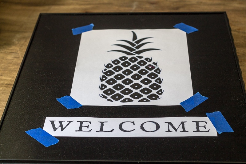 Pineapple image and welcome word taped to frame