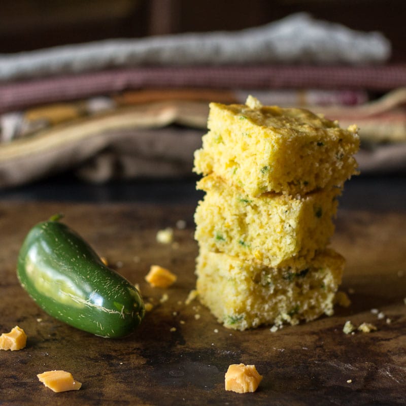 Smoky jalapeno cheddar cornbread is simple to make. The key is blistering jalapeno peppers over a flame to give the cornbread a nice smoky kick.