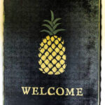 A painted gold pineapple welcome sign.