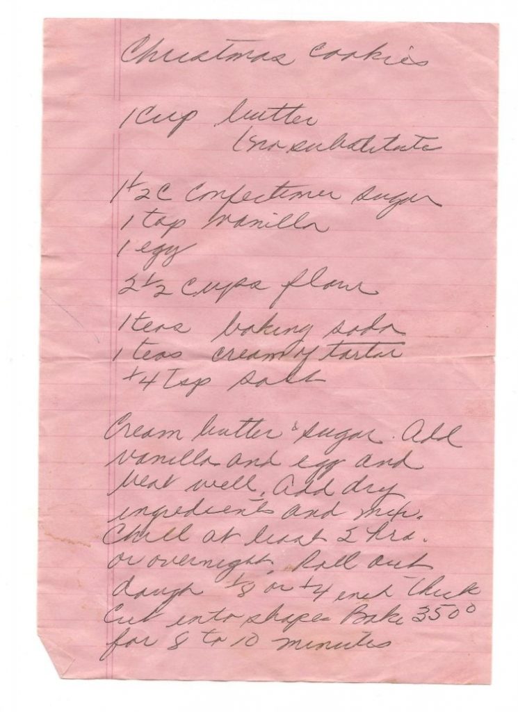 Pink ruled paper with handwritten Christmas cookie recipe on it.