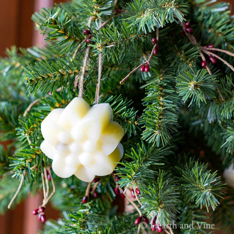 Handmade beeswax ornament hanging on a Christmas tree