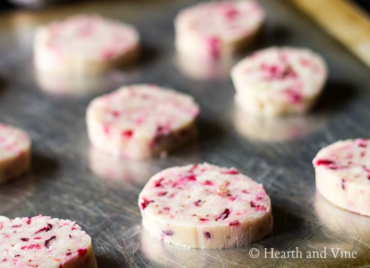 Cranberry cookie dough slices on cookie sheet