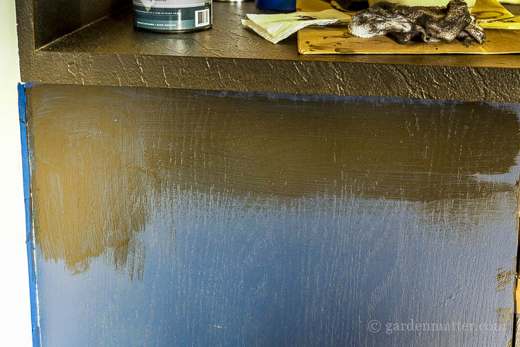 Painting bar cabinet with blue paint and black glaze.