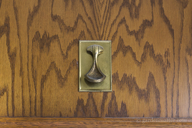 Original oak cabinet with brass pull.