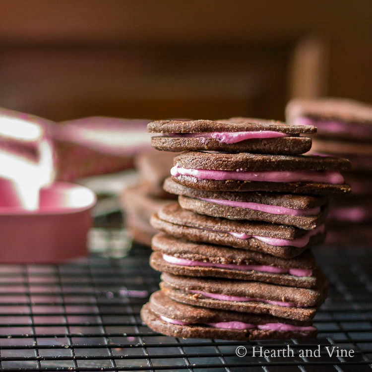 Stack of chocolate heart cookies with pink buttercream filling