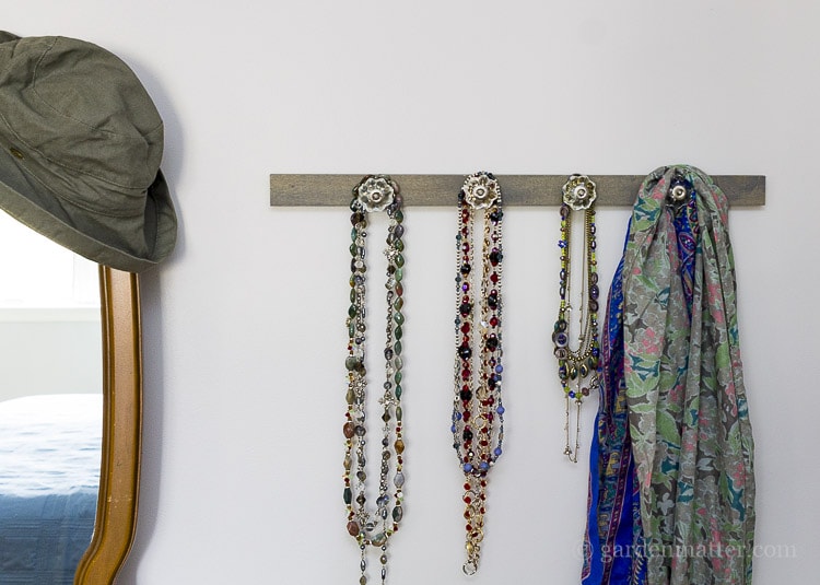 DIY drawer pulls on wood for a jewelry hanger.