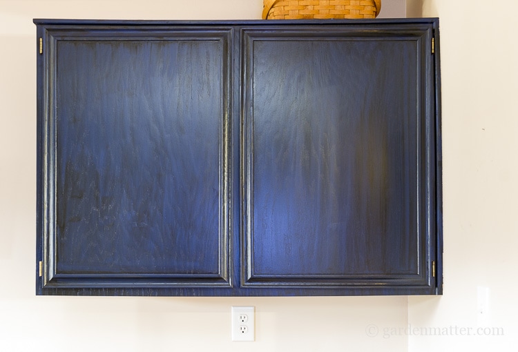 Painting oak cabinets with blue paint and black glaze.