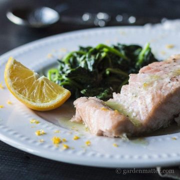 Meyer lemon butter sauce on baked salmon and wilted fresh spinach.