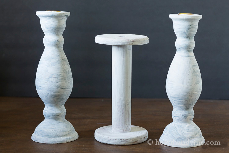 White base coat on wooden candlesticks.