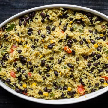 Oval casserole dish with Mexican black beans and rice.