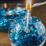 Blue gems in round vase with lamp oil and insert for a patio lantern.