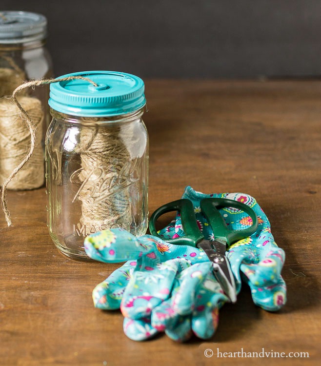 garden gloves scissors and mason jar with jute