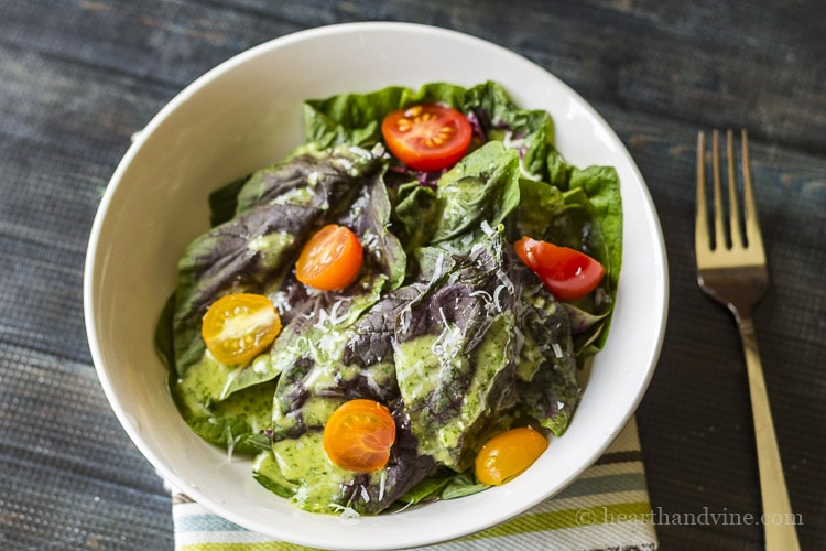 Red greens salad with tomatoes in a bowl