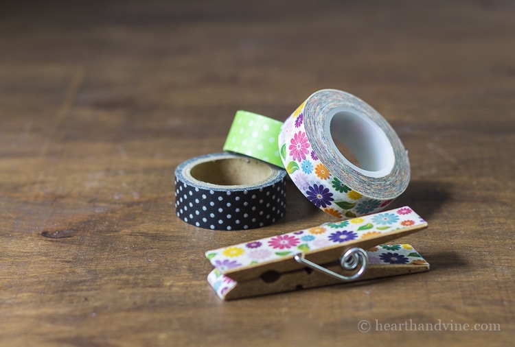 Rolls of washi tape and floral washi tape on a wooden clothespin.