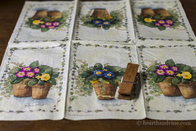 Flower pot printed napkin and a wooden clothespin.