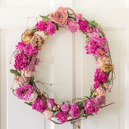 Dried peony wreath on white door.