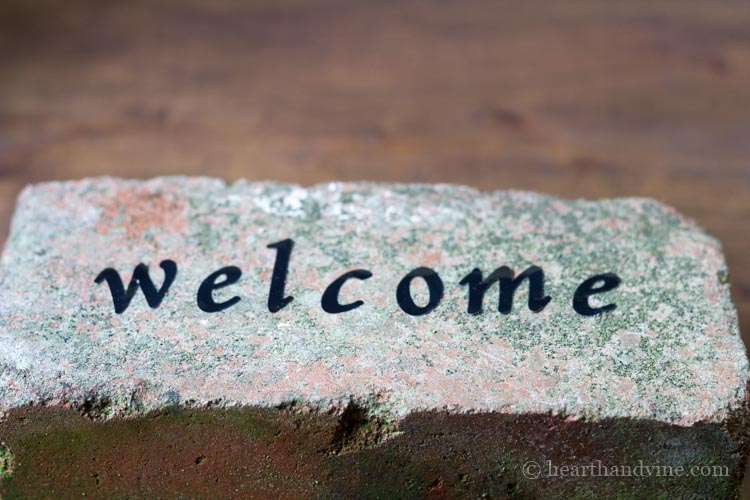 Brick with welcome sticker letters.