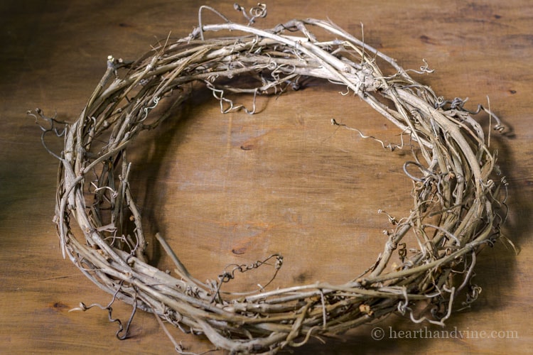 Wild grapevine wreath on table.