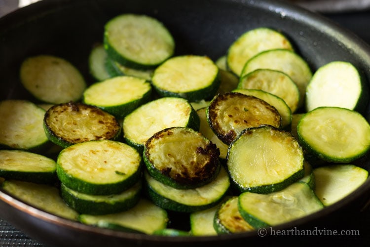 Sauteed zucchini sliced in pan.