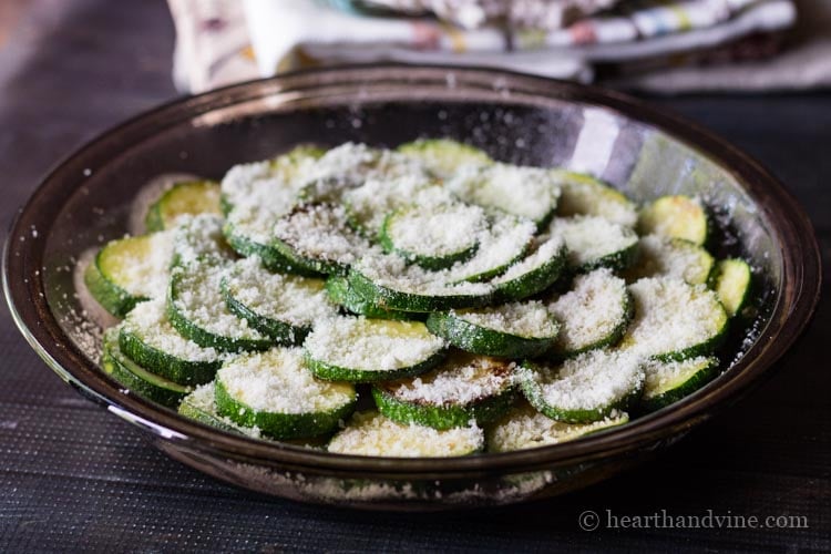 Layered zucchini slices topped with Parmesan cheese.